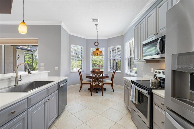 kitchen featuring a sink, visible vents, light countertops, gray cabinetry, and appliances with stainless steel finishes