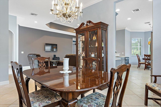 dining room featuring light tile patterned floors, visible vents, crown molding, and baseboards