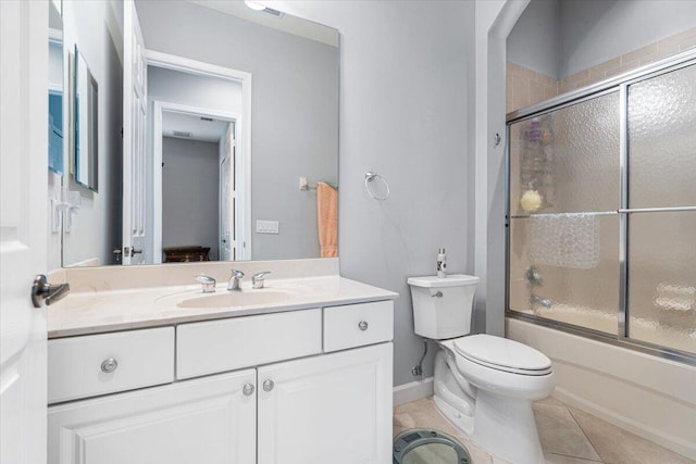 full bathroom with tile patterned floors, enclosed tub / shower combo, toilet, vanity, and baseboards
