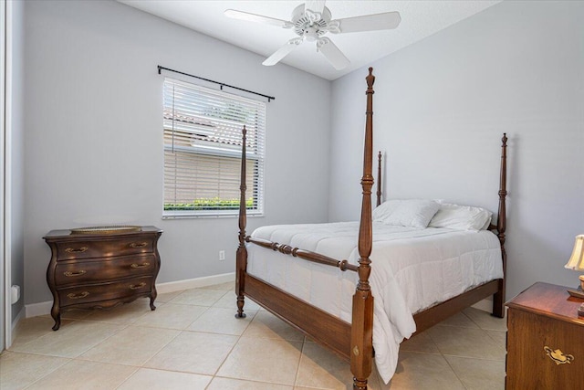 bedroom featuring baseboards, a ceiling fan, and light tile patterned flooring