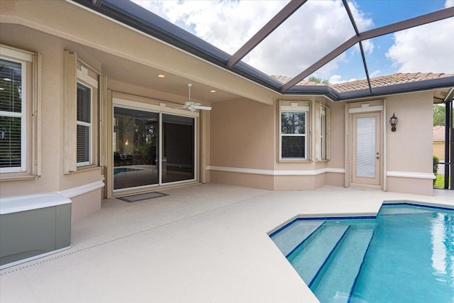 pool featuring a lanai, ceiling fan, and a patio area
