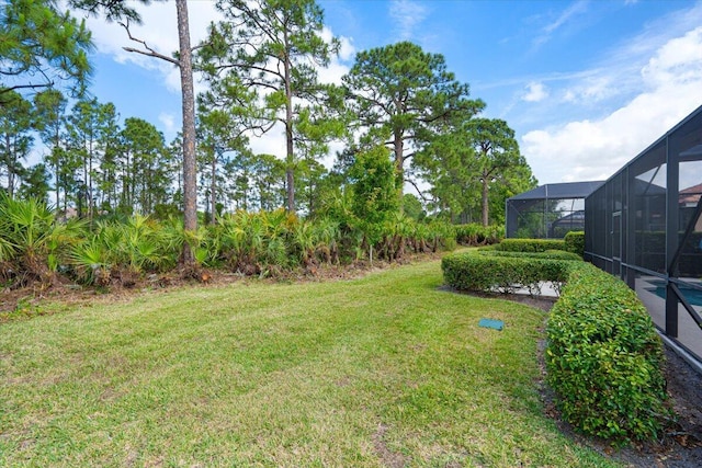 view of yard featuring glass enclosure