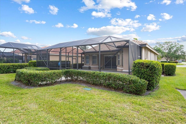 back of property featuring a yard