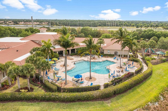 community pool featuring a patio and fence