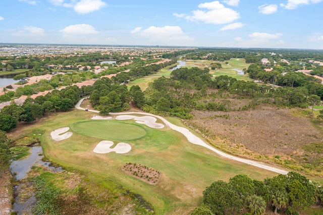 birds eye view of property with view of golf course and a water view
