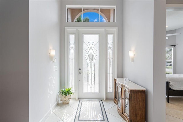 foyer entrance with baseboards and plenty of natural light