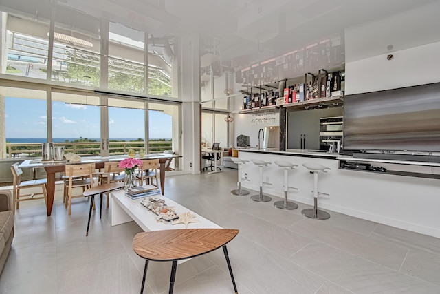 4101 N Ocean Blvd Unit 504, Boca Raton, FL 33431 - interior space with a high ceiling, expansive windows, and a sink