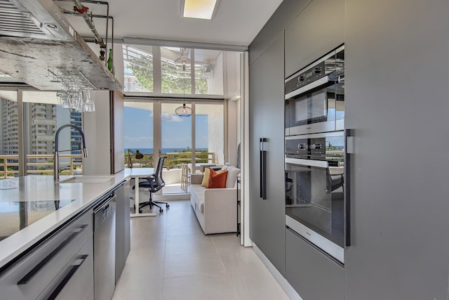 4101 N Ocean Blvd Unit 504, Boca Raton, FL 33431 - kitchen with stainless steel dishwasher, modern cabinets, a sink, and gray cabinets