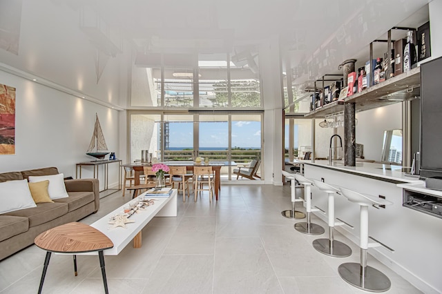 4101 N Ocean Blvd Unit 504, Boca Raton, FL 33431 - tiled living area featuring a high ceiling