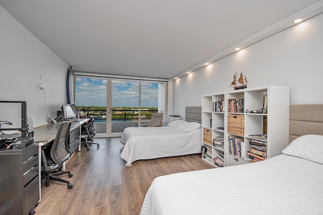 4101 N Ocean Blvd Unit 504, Boca Raton, FL 33431 - bedroom with wood finished floors, expansive windows, and access to exterior
