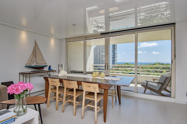 4101 N Ocean Blvd Unit 504, Boca Raton, FL 33431 - dining space with tile patterned flooring, a water view, and expansive windows