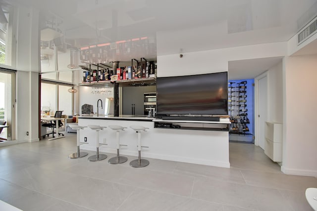 4101 N Ocean Blvd Unit 504, Boca Raton, FL 33431 - bar featuring light tile patterned floors, visible vents, bar, and plenty of natural light