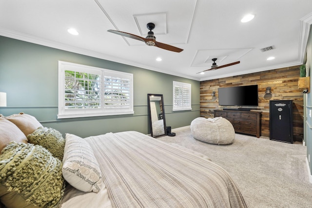 bedroom with visible vents, ornamental molding, wooden walls, and multiple windows