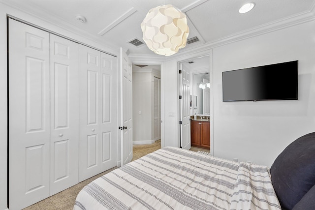 bedroom featuring ornamental molding, a closet, connected bathroom, and visible vents
