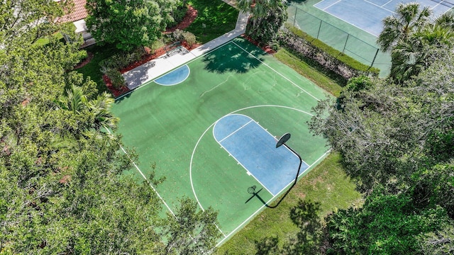 view of basketball court featuring fence and community basketball court