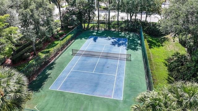 view of tennis court featuring fence