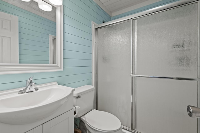 full bath with toilet, a shower stall, wooden walls, and vanity