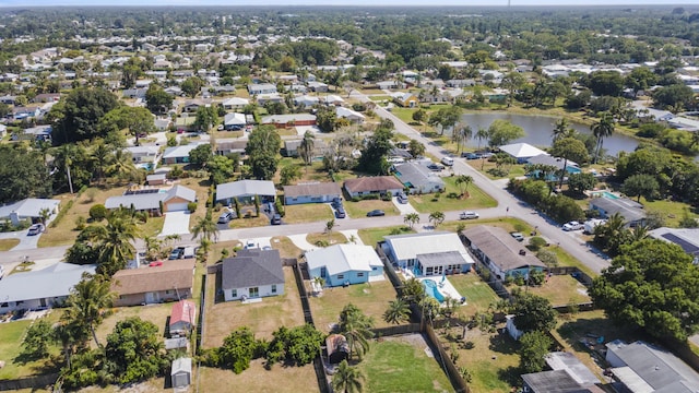 drone / aerial view featuring a water view and a residential view