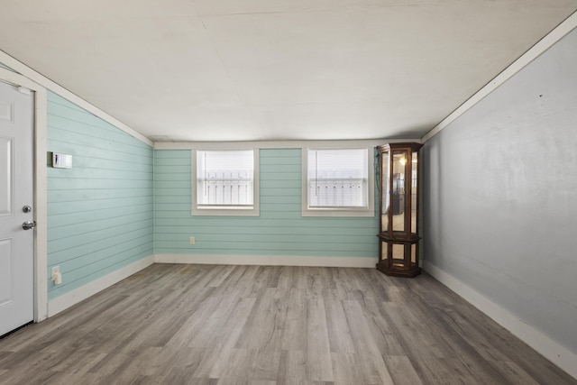 empty room featuring wood finished floors and baseboards