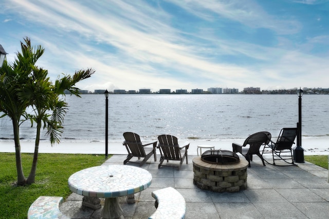 1432 S Lakeside Dr Unit 11, Lake Worth Beach, FL 33460 - view of patio featuring a water view and an outdoor fire pit