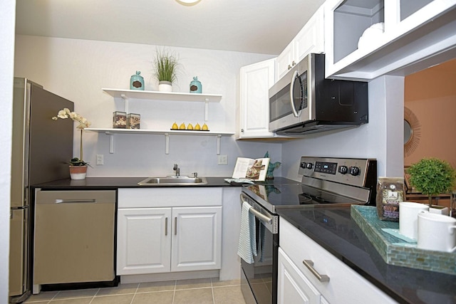 1432 S Lakeside Dr Unit 11, Lake Worth Beach, FL 33460 - kitchen with a sink, dark countertops, stainless steel appliances, and white cabinetry