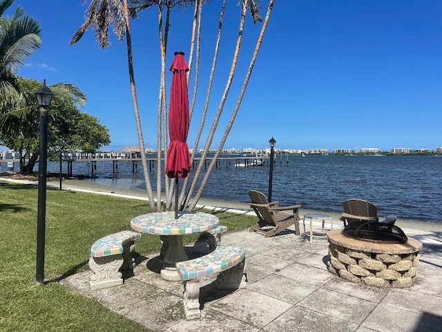 1432 S Lakeside Dr Unit 11, Lake Worth Beach, FL 33460 - exterior space with a lawn, a water view, a fire pit, and a patio area