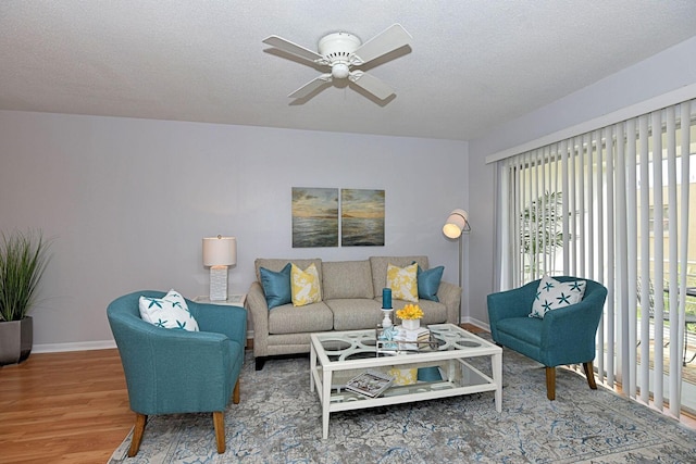 1432 S Lakeside Dr Unit 11, Lake Worth Beach, FL 33460 - living room with baseboards, a ceiling fan, wood finished floors, and a wealth of natural light