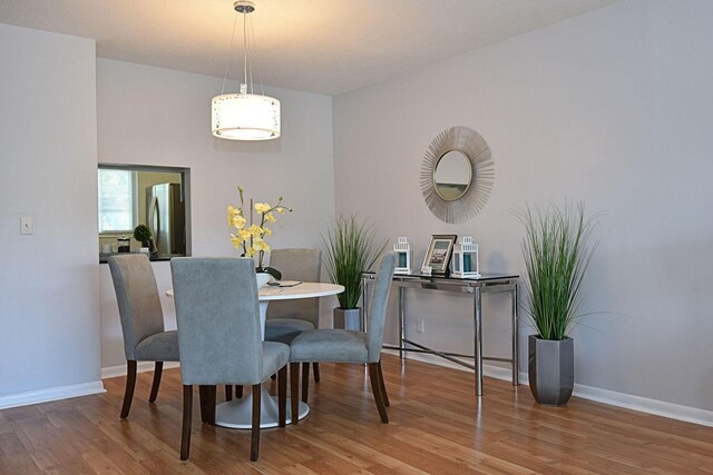 1432 S Lakeside Dr Unit 11, Lake Worth Beach, FL 33460 - dining room featuring baseboards and wood finished floors
