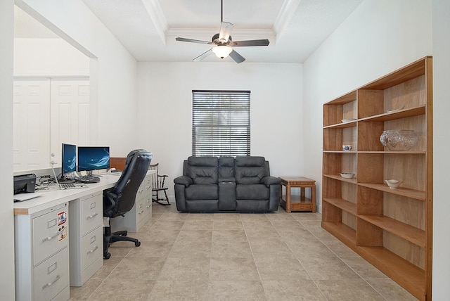 office space featuring a raised ceiling, ornamental molding, and ceiling fan