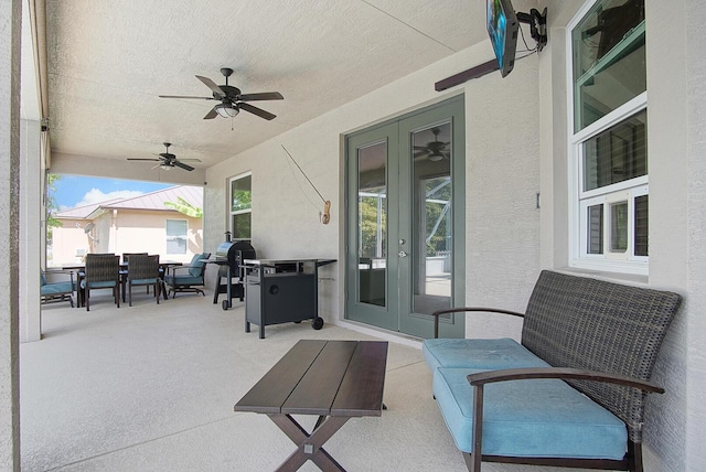 view of patio with outdoor dining area, french doors, and ceiling fan