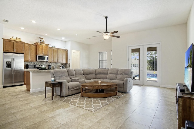 living area featuring french doors, a ceiling fan, visible vents, baseboards, and recessed lighting
