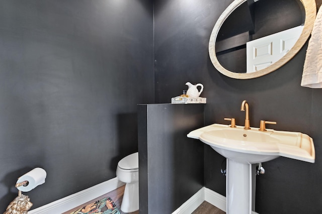 210 Via Villagio, Hypoluxo, FL 33462 - half bathroom featuring baseboards, wood finished floors, and toilet