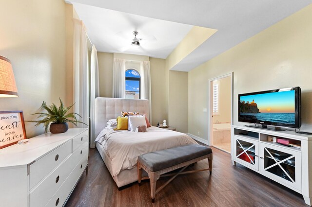 210 Via Villagio, Hypoluxo, FL 33462 - bedroom with connected bathroom, baseboards, and dark wood-type flooring