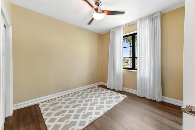 210 Via Villagio, Hypoluxo, FL 33462 - empty room featuring baseboards, ceiling fan, and wood finished floors
