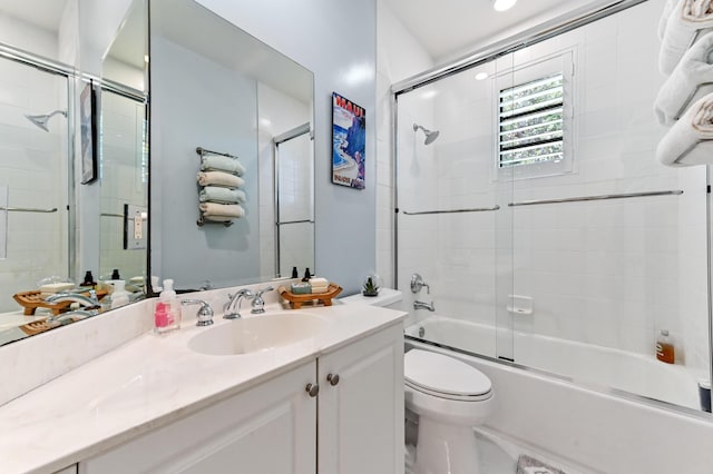 210 Via Villagio, Hypoluxo, FL 33462 - bathroom featuring toilet, combined bath / shower with glass door, and vanity