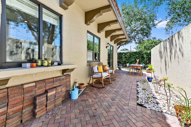 210 Via Villagio, Hypoluxo, FL 33462 - view of patio / terrace featuring a fenced backyard and outdoor dining space
