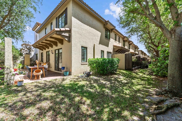 210 Via Villagio, Hypoluxo, FL 33462 - rear view of property with fence, a patio, stucco siding, and a tiled roof
