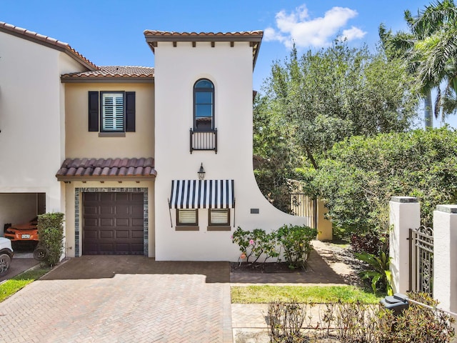210 Via Villagio, Hypoluxo, FL 33462 - mediterranean / spanish home featuring a garage, decorative driveway, stucco siding, and a tile roof