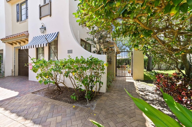 210 Via Villagio, Hypoluxo, FL 33462 - exterior space featuring a gate and a garage
