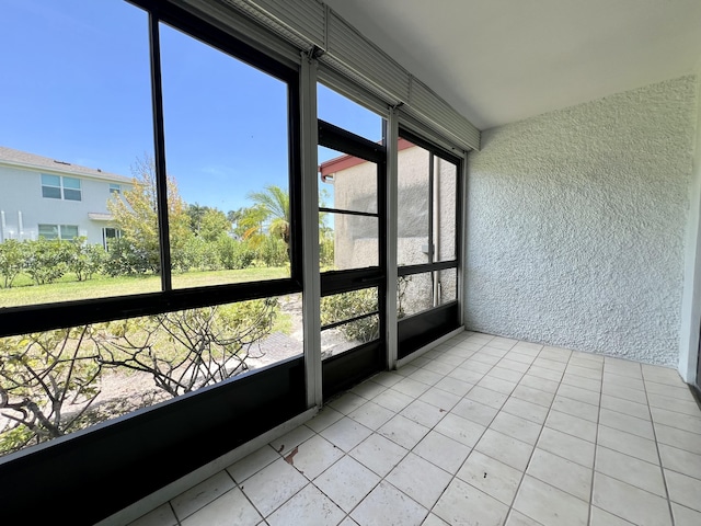 4345 Trevi Ct Unit 108, Lake Worth, FL 33467 - unfurnished sunroom featuring tile patterned flooring, plenty of natural light, and a textured wall