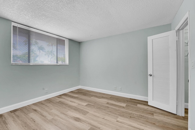 4345 Trevi Ct Unit 108, Lake Worth, FL 33467 - unfurnished bedroom with wood finished floors and a textured ceiling