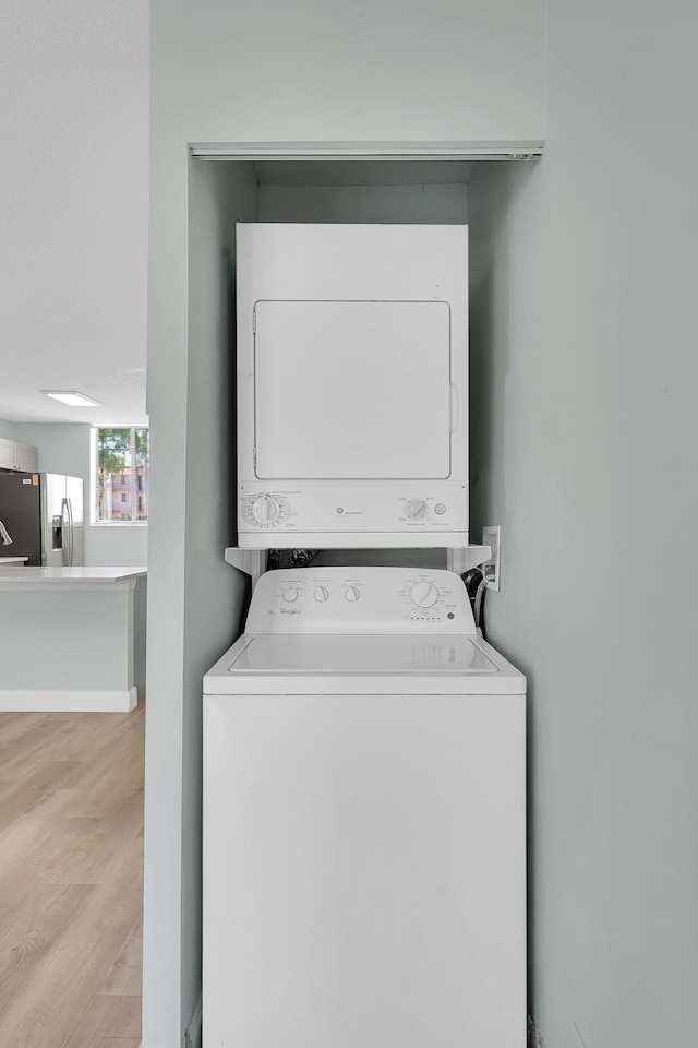 4345 Trevi Ct Unit 108, Lake Worth, FL 33467 - washroom with stacked washer / drying machine and wood finished floors