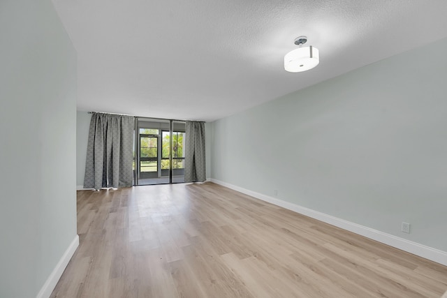 4345 Trevi Ct Unit 108, Lake Worth, FL 33467 - empty room featuring light wood-type flooring and a textured ceiling