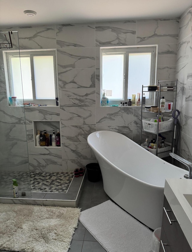 6807 Via Regina Unit 1, Boca Raton, FL 33433 - full bath with plenty of natural light, a marble finish shower, a freestanding tub, and tile patterned floors
