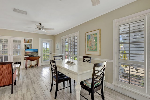 2940 SE Treasure Island Rd, Port Saint Lucie, FL 34952 - dining space with a ceiling fan, crown molding, visible vents, and light wood-type flooring