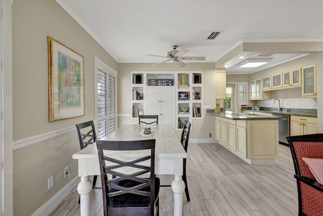 2940 SE Treasure Island Rd, Port Saint Lucie, FL 34952 - dining room featuring ceiling fan, light wood-style flooring, visible vents, and ornamental molding