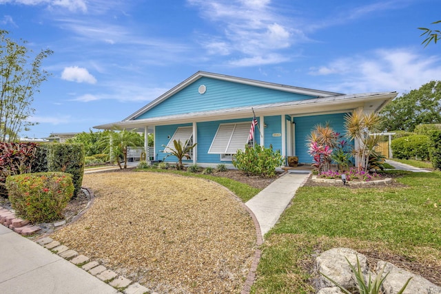 2940 SE Treasure Island Rd, Port Saint Lucie, FL 34952 - view of front facade featuring a front lawn and a porch