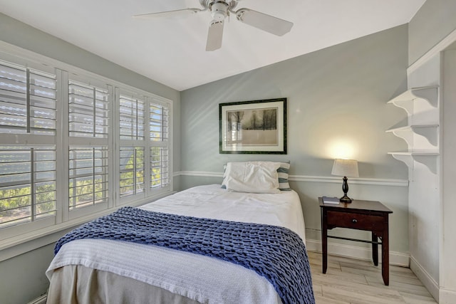 2940 SE Treasure Island Rd, Port Saint Lucie, FL 34952 - bedroom featuring baseboards, a ceiling fan, and wood finished floors