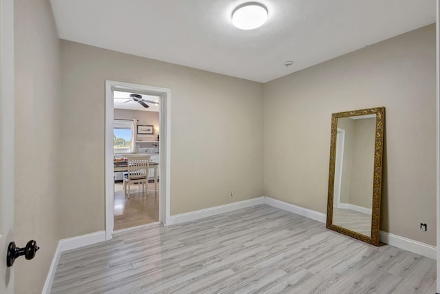 2940 SE Treasure Island Rd, Port Saint Lucie, FL 34952 - spare room featuring baseboards, light wood-style floors, and ceiling fan
