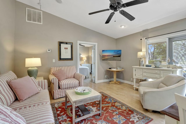 2940 SE Treasure Island Rd, Port Saint Lucie, FL 34952 - living room with lofted ceiling, visible vents, light wood-style flooring, and ceiling fan